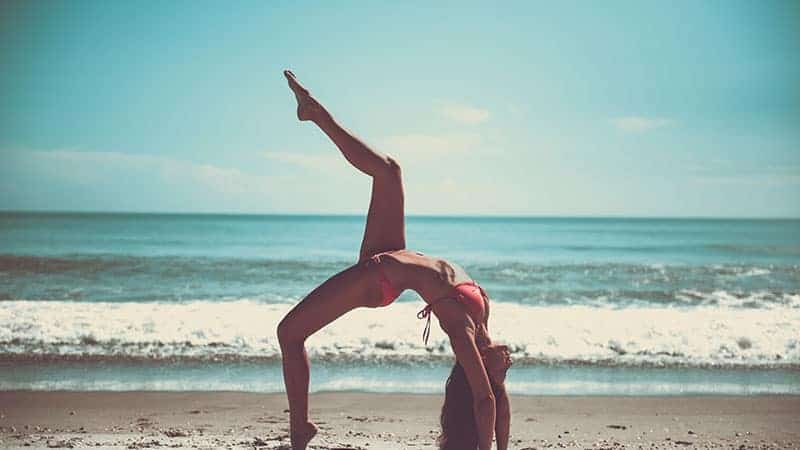 Flexible girl on the beach