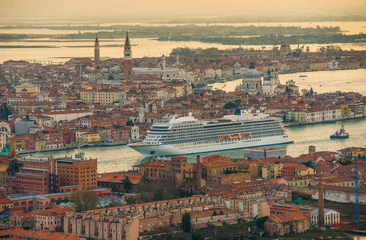 Viking Ocean Cruises Orders More Ships Cruise ship sailing through Venice at sunset.