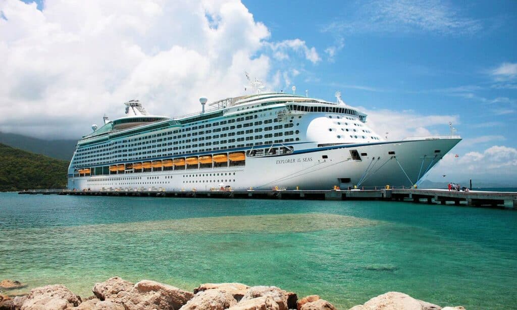 Royal Caribbean cruise ship at dock on a sunny day.