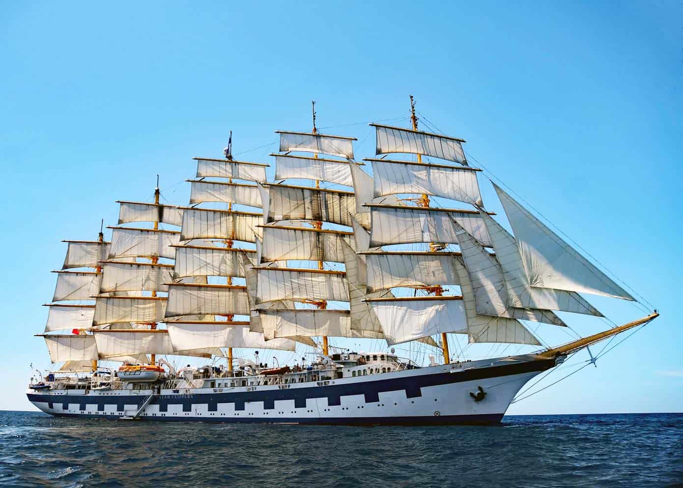 Large sailing ship in the ocean on a gorgeous day with blue skies.