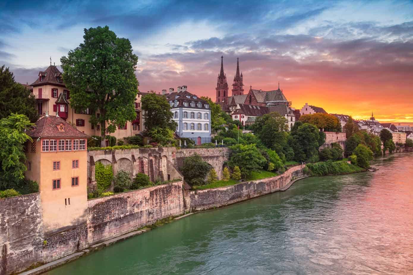 Old medieval style buildings along the Rhine River during sunset.