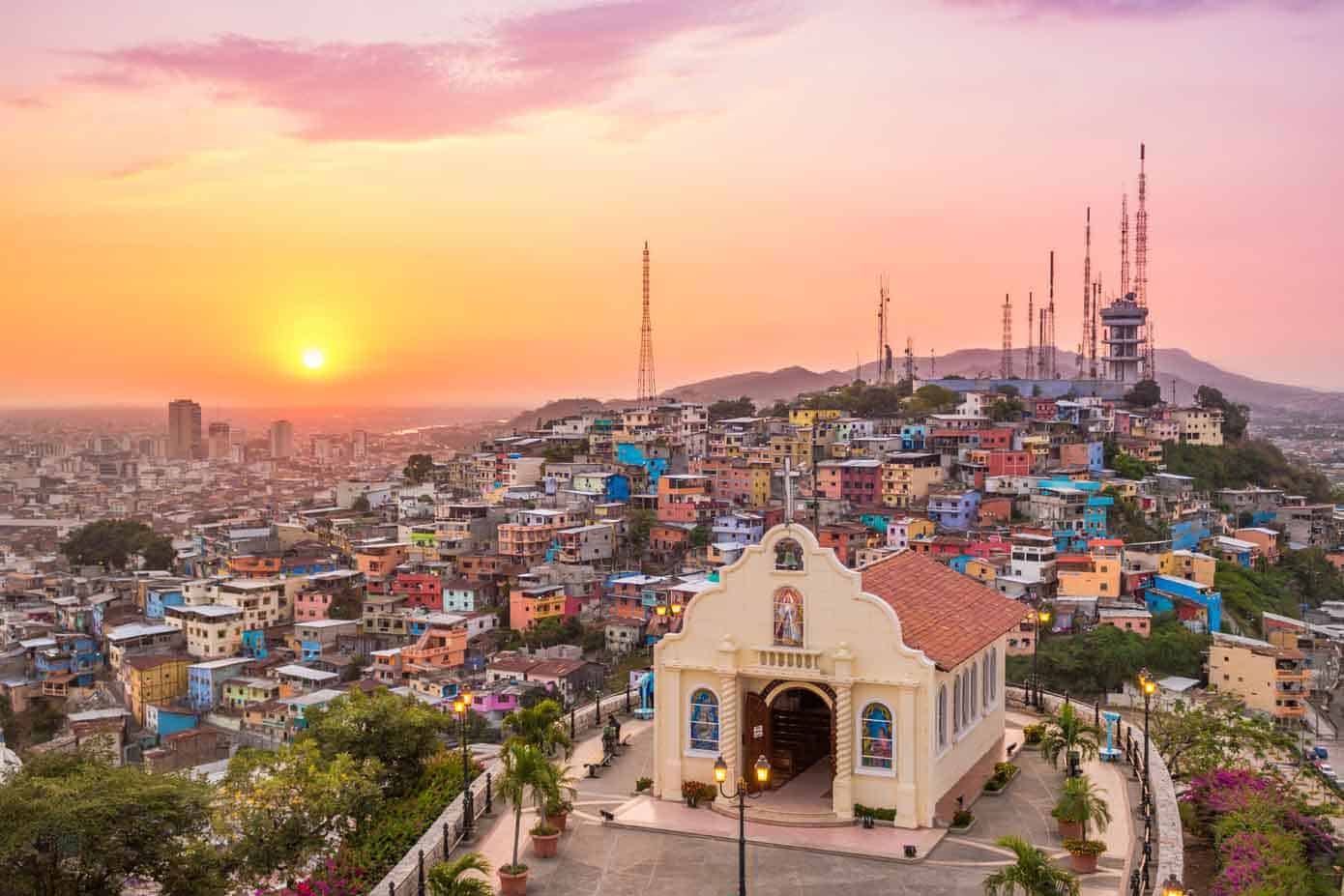 Sunset over hills and sprawling city in Guayquil, Ecuador.