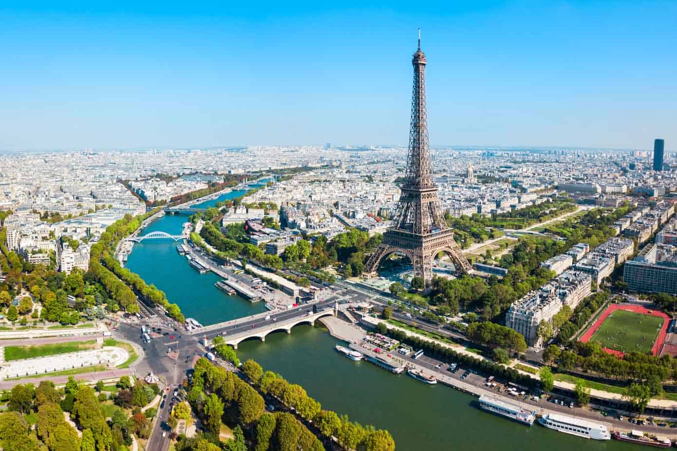 Aerial view of the Eiffel Tower and Seine River with city in the background in Paris, France.