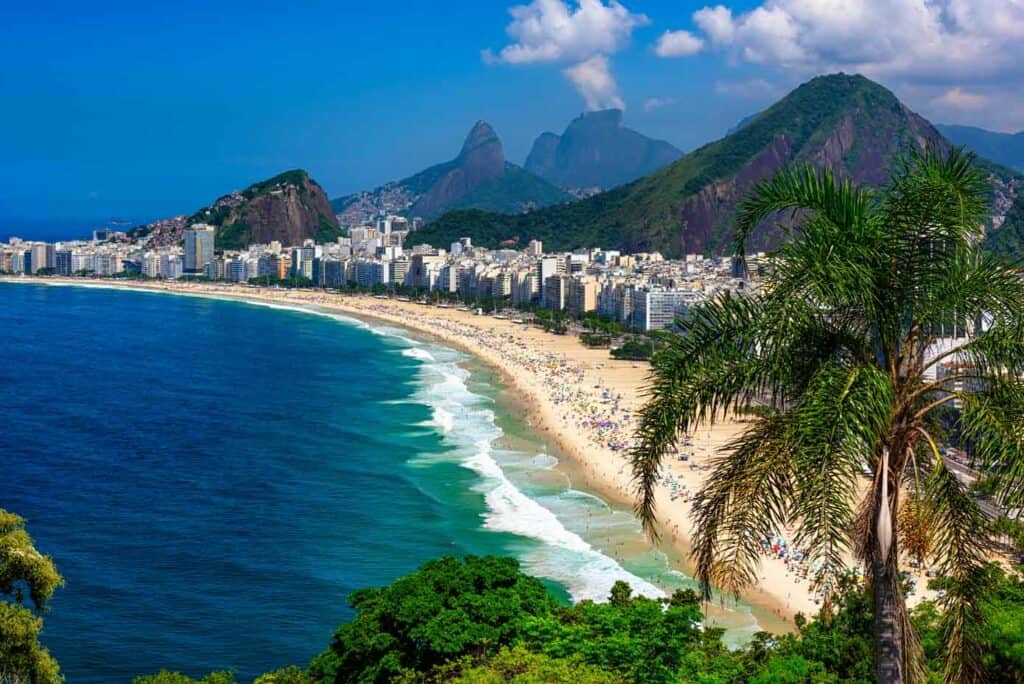 Copacabana beach with mountains in the background in Rio de Janeiro, Brazil.