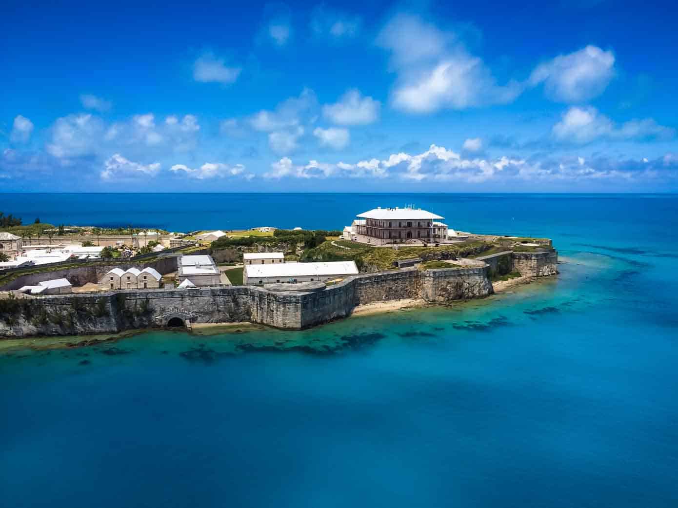 Old fortress called Royal Naval Dockyard in Bermuda jetting into a beautiful blue ocean.