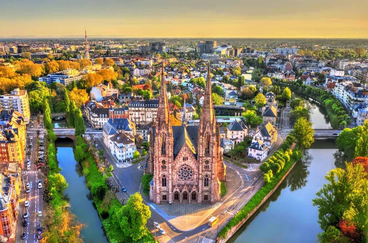 View of city, canal, and Saint Paul Church in Strasbourg, Alsace, France.