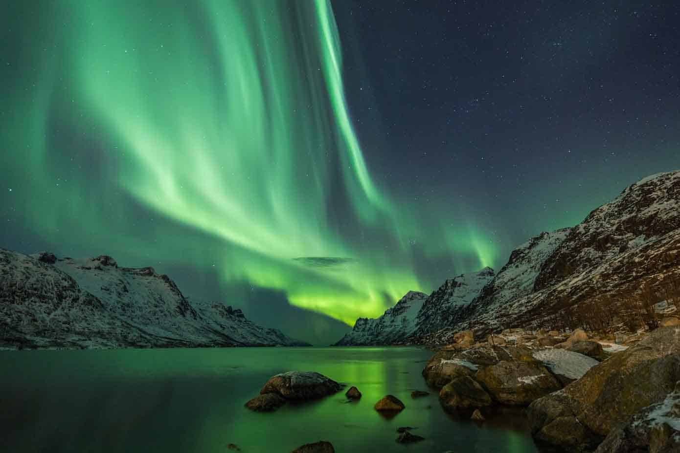 Northern lights between two fjords in Tromso, Norway.