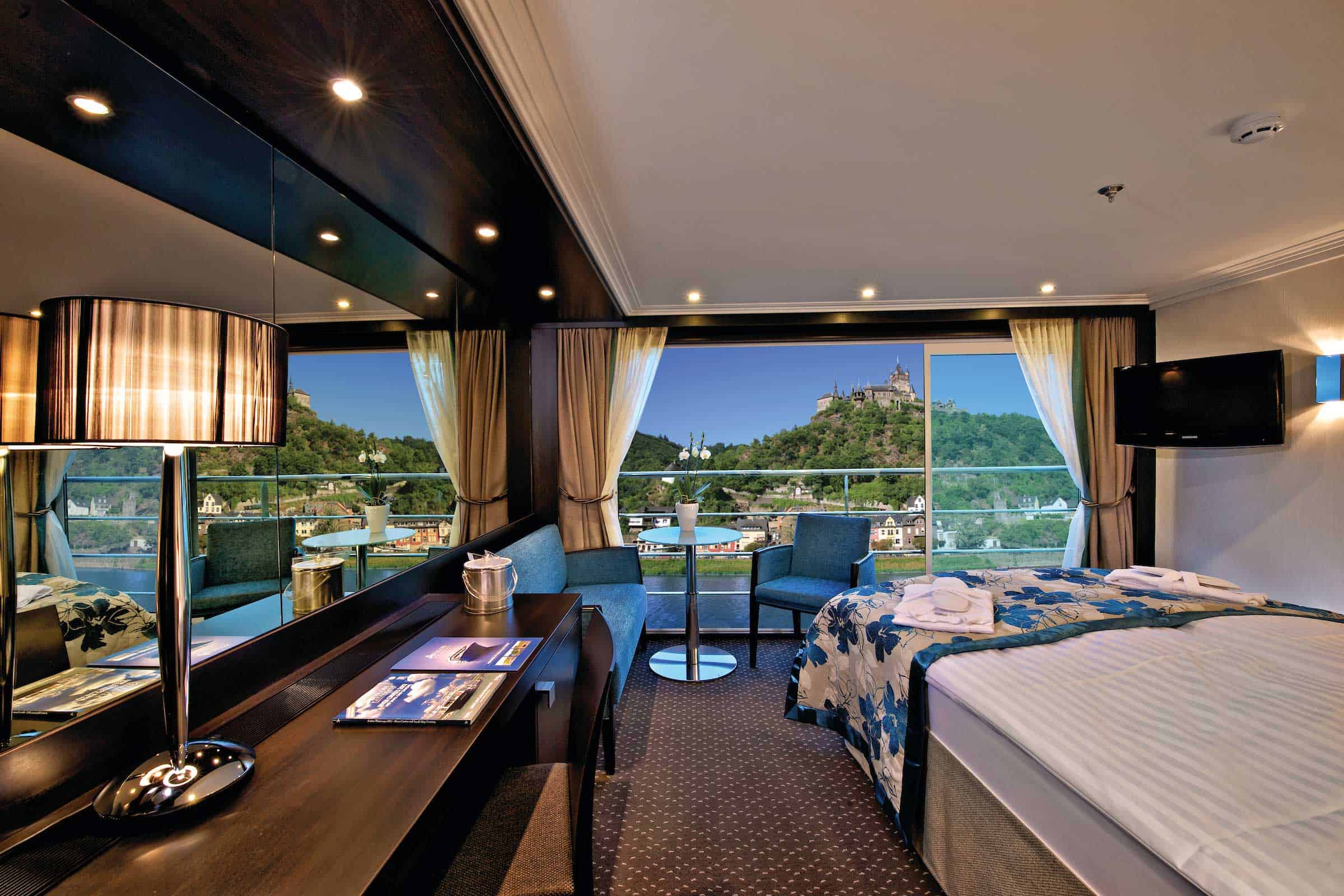 Luxurious cruise ship cabin with balcony.