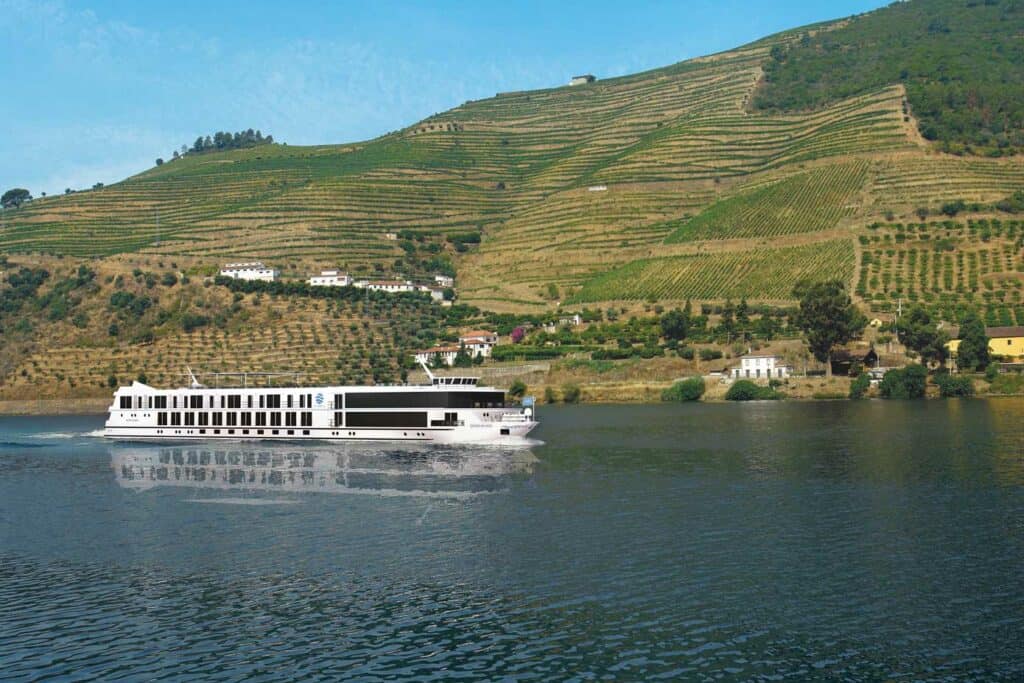 Cruise ship sailing down a river.