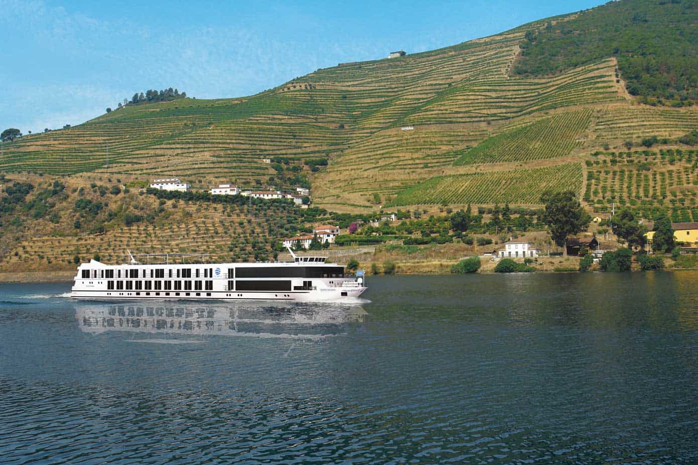 Cruise ship sailing down a river.