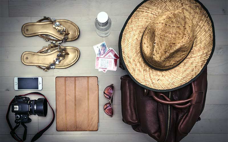 Phone, camera, hat, sandals, and sunglasses.