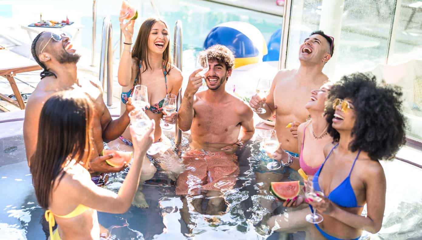 8 Best Cruise Lines for Young Adults Group of young adults celebrating in a pool.