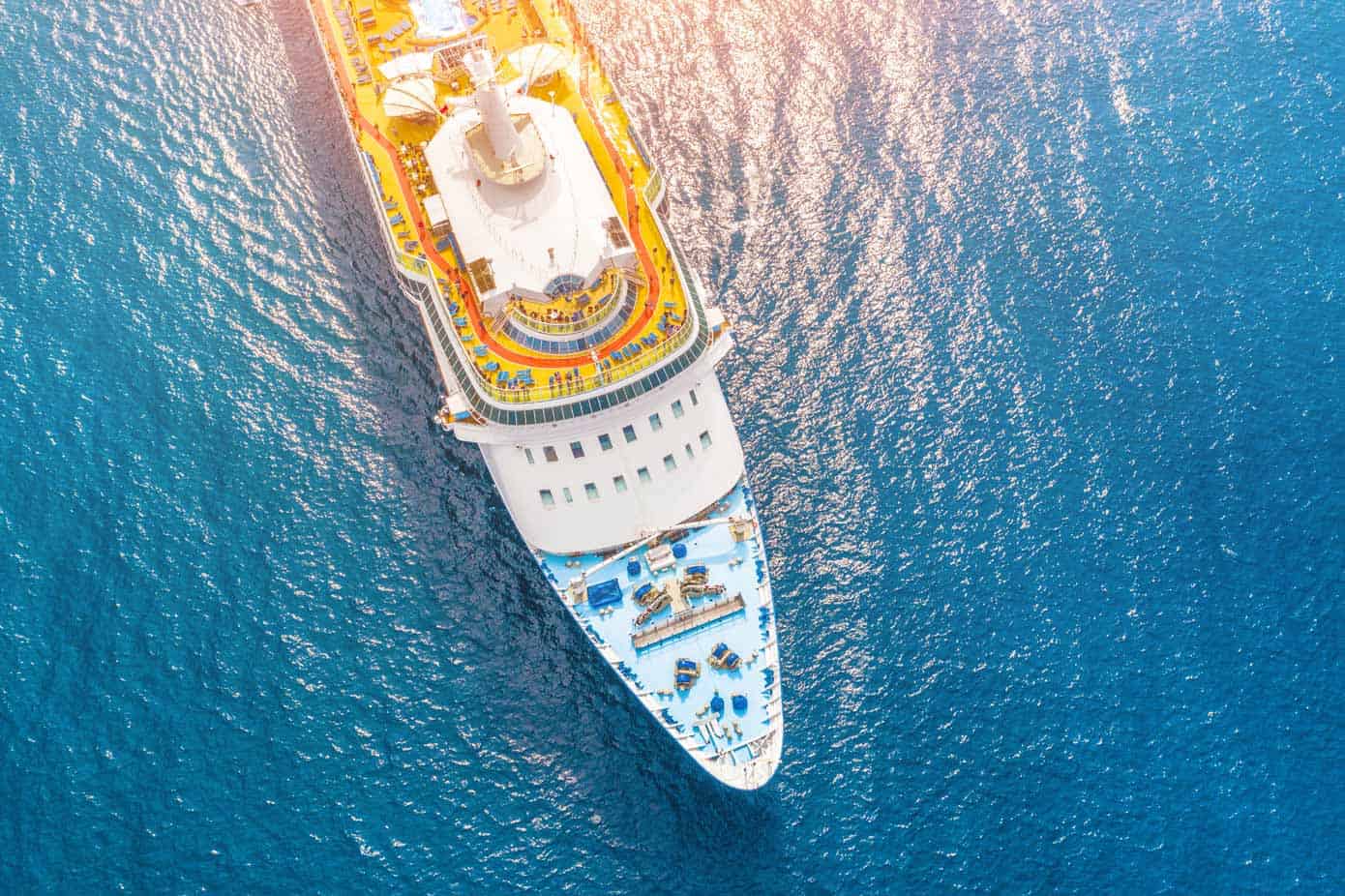 Aerial view of a cruise ship in a turquoise ocean.