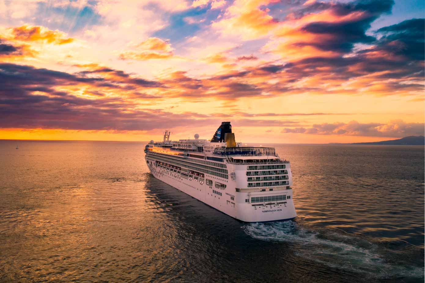 Best Cruises from Boston, Massachusetts Norwegian Gem cruise ship at sunset.