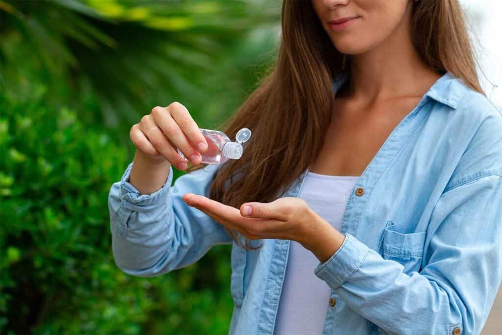 woman applying hand sanitizer.