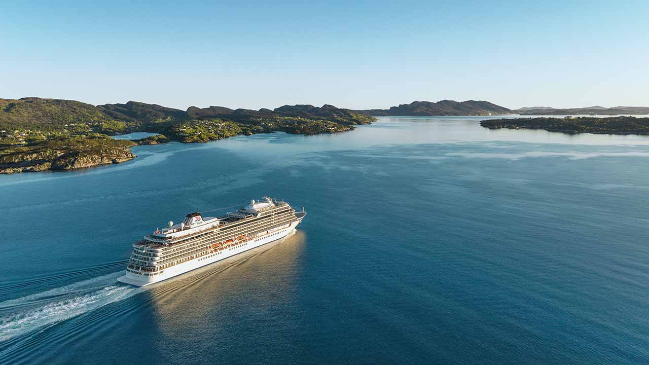 Viking Ocean Cruises: Special Offer Ocean viking ship, aerial, mountains in background.