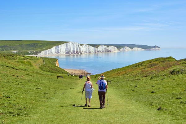 Walking down a hill towards the beach.